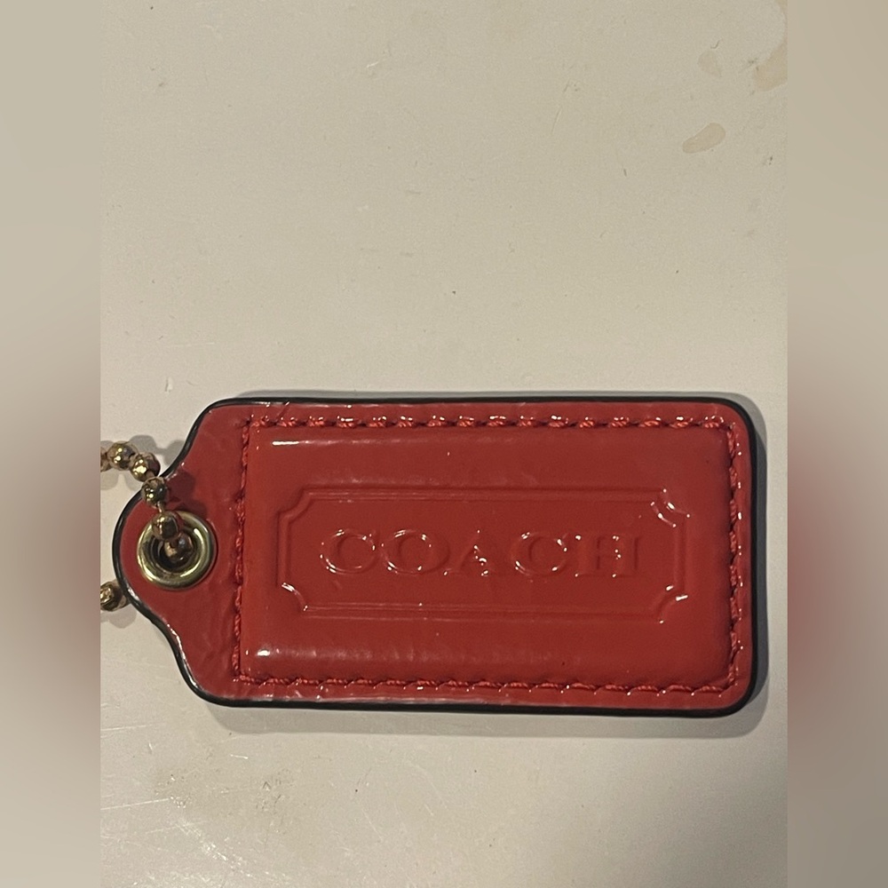 Coach Glossy orange Leather Hang tag